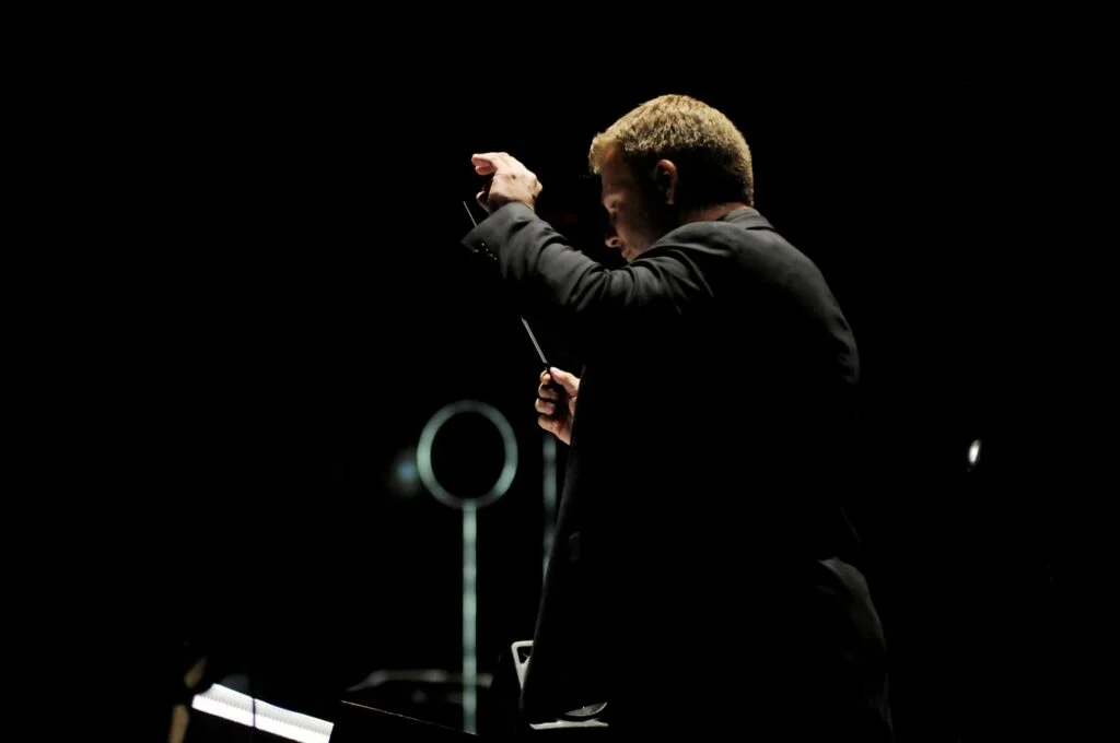 John Jesensky conducting an orchestra on stage